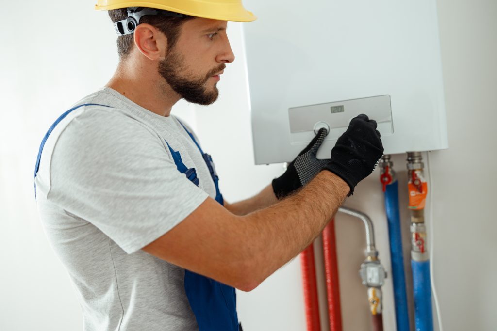 Technician installing water heater